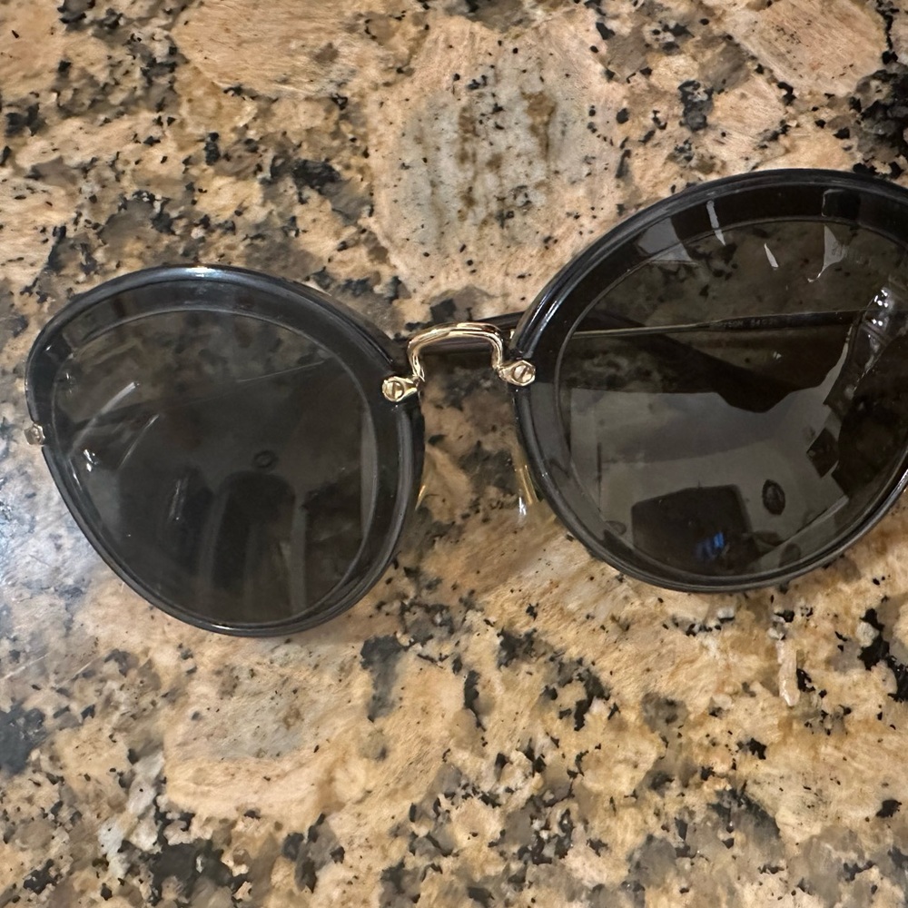 Miu Miu Black Round Sunglasses with Metallic Accents